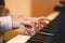 Children`s hands on the piano keys, rehearsal music, learning to play the piano