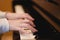 Children`s hands on the piano keys, rehearsal music, learning to play the piano