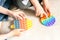 Children& x27;s hands play fashionable sensory bright toy anti-stress pop it. Silicone toy with soft bubbles relieve stress