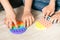 Children& x27;s hands play fashionable sensory bright toy anti-stress pop it. Silicone toy with soft bubbles relieve stress