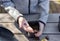 Children`s hands put plant seeds in a seedling pot, standing on a wooden table.