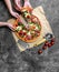 Children`s hands take homemade pizza with salami