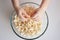 Children`s hands take popcorn in a plate. background for popcorn and movie day decoration.