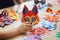 Children\\\'s hands working on homemade paper animal crafts