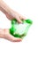 Children`s hands wrinkle, stretch, manipulate with a green transparent slime. Trend for children and youth. Isolate