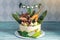 Children\'s holiday white cake decorated with dinosaurs in the Jurassic period jungle. Concept ideas desserts for kids