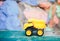 Children`s machine yellow truck. Close-up