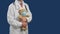 Children& x27;s medical doctor with a stethoscope holds a teddy bear in a medical mask.