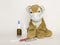 Children`s medicine. Soft children`s toy tiger in a medical disposable mask on a white background. Medications and pills are nearb