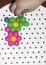 Children`s mosaic. the child lays a flower out of a colored plastic mosaic. the child`s hand holds a bright plastic mosaic piece