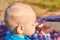 Children`s nape with sparse white hair, close-up. Mom feeds baby pastila