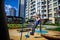 Children\\\'s obstacle course on a modern playground. Kid crossing a wooden bridge or other barriers using his body balance.