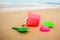 Children`s pail and colored molds on the beach in the sand