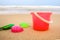 Children`s pail and colored molds on the beach in the sand