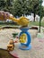 Children\\\'s playground. A child plays in the sand. Mom is filming a child playing on her phone. Banner, web page, site