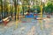 Children`s playground in a city Park early in the morning, various swings and carousels