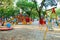 Children`s playground in a city Park early in the morning, various swings and carousels