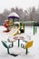 Children`s playground is covered with a thick layer of snow.