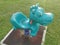 Children`s playground with cyan colored dinosaur spring toy rider