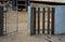 At a children`s playground separated by a metal gate with a net string. fencing made of wood gray concrete. protection of the sand