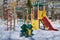 A children`s Playground with a slide, a ladder, swings, a rope and a frog rocking chair.