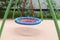 Children`s playground with swings. Rope circle blue on a swing. Children`s entertainment