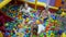 Children`s playroom. Children play in a dry basin filled with plastic colored balls.