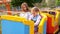 Children`s roller coaster. car with girls rides on rails in amusement Park