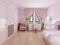 Children`s room for girls in classic style in light pink colors and white furniture