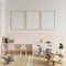 Children`s room with a picture frame on the walls in white and cream colors. With books placed on the table and toys on the floor