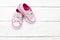 Children`s shoes for girls in florets on a wooden background. Fl