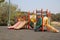 Children`s slider activities Colorful children`s playgrounds in the field in the outdoor park Childhood fun