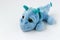 Children`s soft toy blue dragon is located on a white background