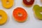 Children\\\'s sweets in the form of multi-colored donuts, chewable, gelatin sweets are located on a white background.