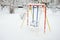 Children& x27;s swing, covered with a thick layer of snow after a heavy snowfall