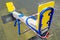 Children\\\'s swing on a playground in a recreation park wrapped with red barrier tape