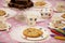 Children\\\'s tea party with colourful spotted crockery, chocolate brownies, cookies and colouring crayons