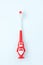 Children& x27;s toothbrush in a form of red penguin on a white background 