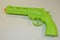 Children`s toy, green plastic revolver