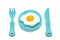 Children`s toy plastic tableware: plate with fried eggs, fork and knife. Serving set