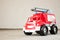 Children`s toy. Red car. Old plastic fire truck.