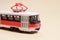 Children's toy red white tram on a beige background copy space for text. Toys for a toy store, cars for a boy.