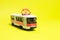 Children's toy red white tram on a yellow background copy space for text. Toys for a toy store, cars for a boy.