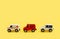 Children's toy, three cars on a yellow background. Police car, fire truck, ambulance. Emergency. Concept. Isolate. Copy