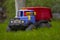 Children`s toy truck colorful car on the green grass