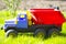 Children`s toy truck colorful car on the green grass