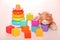 Children`s toys, colorful plastic bricks at the table. Children`s pyramid of rings and bright construction blocks