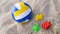 Children`s toys on the sand, soccer ball and colorful sand molds