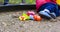 children's toys in the sandbox on the squeak. green pear, red duck, blue butterfly