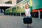 Children`s travel, travel with a child. The child goes to sea, on vacation. A girl with a suitcase in her hands is standing on th